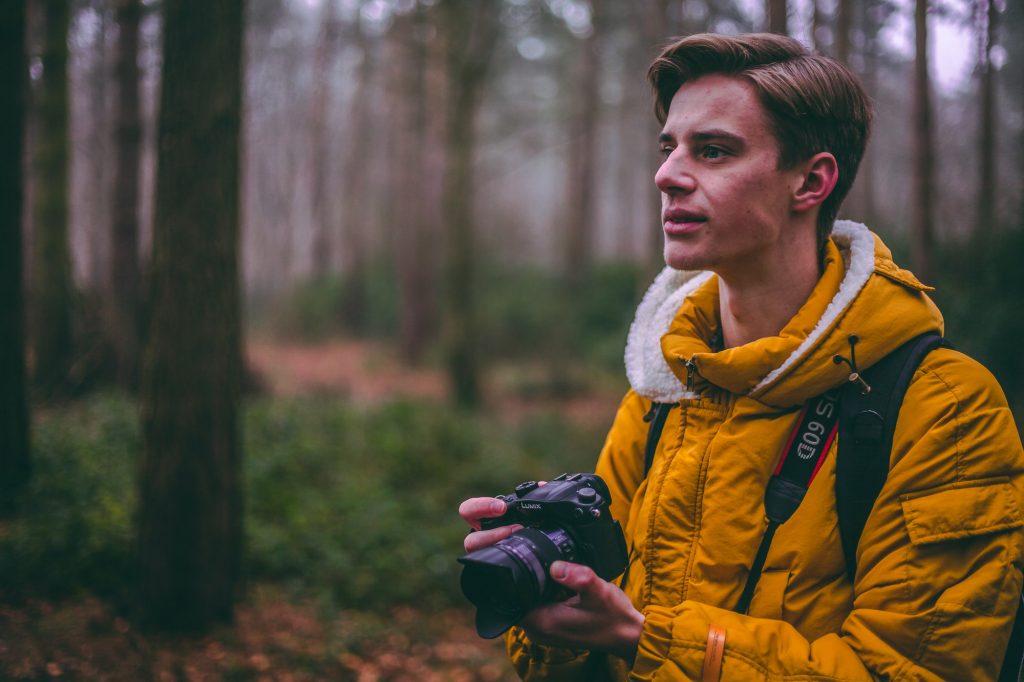 travel photographer in the forest